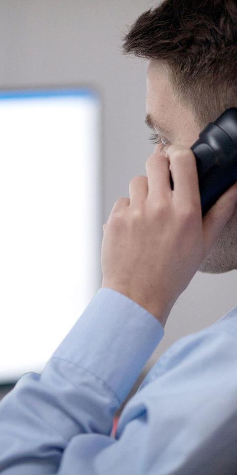A staff member taking a call at Gneiss Energy's office.